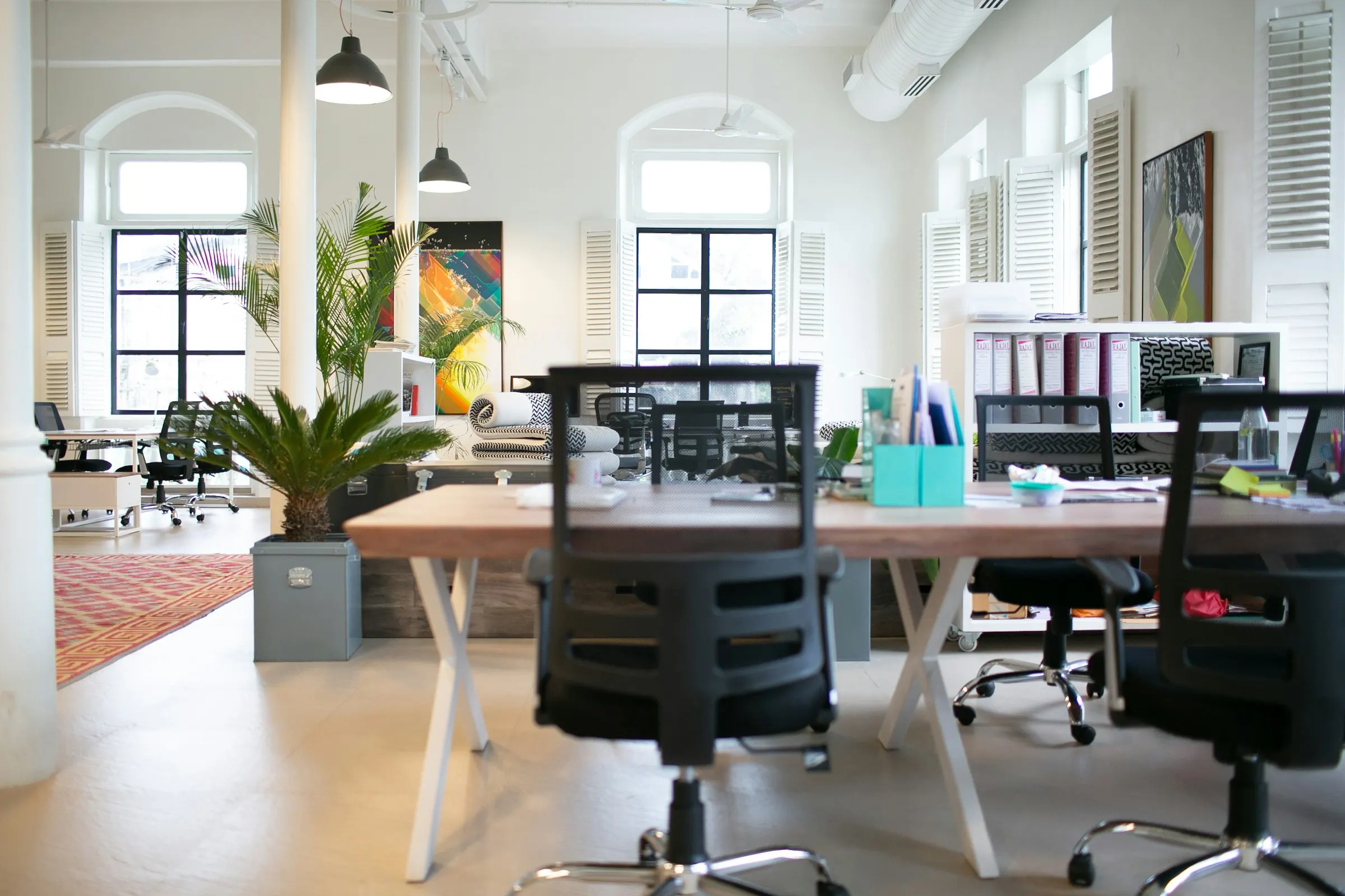 An office floor with desks and natural light